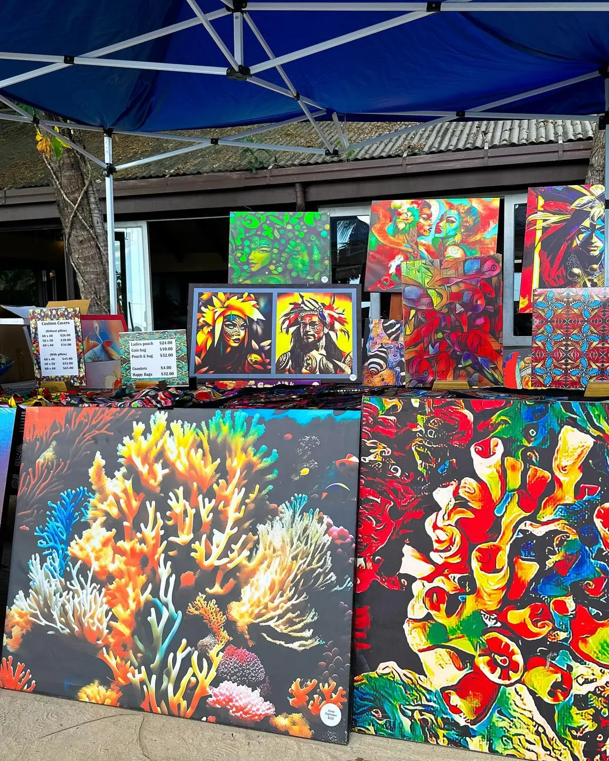 An outdoor display of Walt Smith canvas artwork